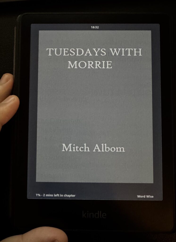 Kindle displaying the cover of 'Tuesdays with Morrie' by Mitch Albom – a heartfelt memoir about life’s greatest lessons. Read the full Tuesdays with Morrie book summary, written by Tapan Desai